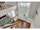 Bright foyer with wood floors, featuring a staircase, large window and front door at 8613 N Meridian St, Indianapolis, IN 46260