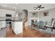 Open-concept kitchen and dining area with white cabinetry, stainless steel appliances, and a fireplace at 8613 N Meridian St, Indianapolis, IN 46260