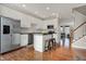 Bright kitchen with white cabinets, stainless steel appliances, and a view into the living area at 8613 N Meridian St, Indianapolis, IN 46260