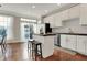 Modern kitchen boasts white cabinets, stainless steel appliances, granite countertops, and hardwood floors at 8613 N Meridian St, Indianapolis, IN 46260