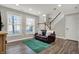 Cozy living room with wood laminate flooring, light gray walls, and ample natural light at 8613 N Meridian St, Indianapolis, IN 46260