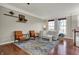Spacious living room with hardwood floors, comfortable seating, and natural light from large windows at 8613 N Meridian St, Indianapolis, IN 46260