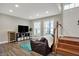 Inviting living room features a TV, seating, and convenient access to stairs at 8613 N Meridian St, Indianapolis, IN 46260