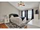 Comfortable main bedroom with a plush bed, ceiling fan, and natural light at 8613 N Meridian St, Indianapolis, IN 46260