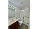 Well-lit bathroom with a vanity, toilet, and glass-enclosed shower at 934 Sorrell Ct, Lebanon, IN 46052