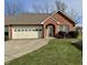 Charming brick home featuring an attached garage and well-maintained front lawn at 934 Sorrell Ct, Lebanon, IN 46052