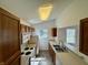 Functional kitchen with white appliances, wood cabinets, and view to dining area at 934 Sorrell Ct, Lebanon, IN 46052