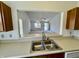 Kitchen sink view to the spacious carpeted living room with lots of light at 934 Sorrell Ct, Lebanon, IN 46052