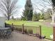 Deck with view of landscaped backyard featuring lush greenery and mature trees at 1054 Carters Grove, Indianapolis, IN 46260