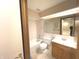 Cozy bathroom featuring a tub, toilet, vanity with sink and neutral-toned tile flooring at 1054 Carters Grove, Indianapolis, IN 46260