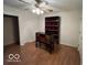 This bedroom features wood-look flooring, a ceiling fan, and built-in storage at 1054 Carters Grove, Indianapolis, IN 46260