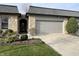 Charming home exterior with stone accents, attached garage and tidy landscaping at 1054 Carters Grove, Indianapolis, IN 46260