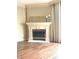 Cozy fireplace with decorative mantle, complemented by sleek flooring and light-filled ambiance at 1054 Carters Grove, Indianapolis, IN 46260