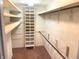 Spacious walk-in closet with ample shelving and hanging rods for optimal storage organization at 1054 Carters Grove, Indianapolis, IN 46260