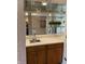 Wet bar features mirrored backdrop, wooden cabinets, laminate countertop and compact stainless sink at 1054 Carters Grove, Indianapolis, IN 46260
