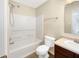 Clean bathroom with a shower-tub combo, neutral finishes, and essential fixtures at 10719 Crackling Dr, Indianapolis, IN 46259