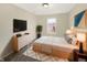 Comfortable bedroom with a modern TV, neutral color scheme, and decorative accents at 10719 Crackling Dr, Indianapolis, IN 46259