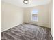 A tranquil bedroom with a view of the water, plush carpeting, and a ceiling light, offering comfort and relaxation at 10719 Crackling Dr, Indianapolis, IN 46259