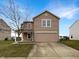 Charming two-story home with neutral siding, attached garage, and well-manicured lawn at 10719 Crackling Dr, Indianapolis, IN 46259