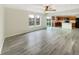 Open-concept living area with wood-look flooring, natural light, and seamless flow to the kitchen at 10719 Crackling Dr, Indianapolis, IN 46259