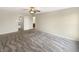 A spacious primary bedroom features plush carpet, a ceiling fan, and an ensuite bathroom, offering a serene retreat at 10719 Crackling Dr, Indianapolis, IN 46259