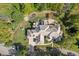 Overhead shot of elegant home with landscaped grounds, fire pit, pergola, and circular driveway at 10821 Club Point Dr, Fishers, IN 46037