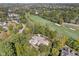 Breathtaking aerial showcases the estate nestled amidst mature trees and a beautifully manicured golf course at 10821 Club Point Dr, Fishers, IN 46037