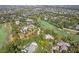 Aerial view captures this beautiful estate nestled amongst lush greenery and manicured golf course at 10821 Club Point Dr, Fishers, IN 46037