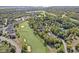 Scenic aerial showcases the community golf course surrounded by lush trees and stately homes at 10821 Club Point Dr, Fishers, IN 46037