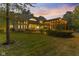 A beautiful two-story home boasts a large lawn and a pergola draped in lights, perfect for backyard entertaining at 10821 Club Point Dr, Fishers, IN 46037