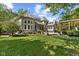 Expansive backyard featuring lush green lawn, mature trees, a pergola, and tasteful landscaping at 10821 Club Point Dr, Fishers, IN 46037
