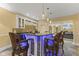 Basement bar area with a dark countertop, white cabinetry, and seating for four with accent lighting at 10821 Club Point Dr, Fishers, IN 46037