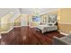 Bright bedroom with hardwood floors, a large window, and light, neutral-colored walls at 10821 Club Point Dr, Fishers, IN 46037