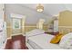 Comfortable bedroom featuring hardwood floors, a sunny window, and unique architectural details at 10821 Club Point Dr, Fishers, IN 46037