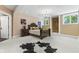 Spacious bedroom boasts a decorative bed frame, carpet flooring, and stone accent wall with lots of natural light at 10821 Club Point Dr, Fishers, IN 46037