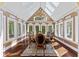 Formal dining room with large windows, a vaulted ceiling, and a grand chandelier creating an elegant ambiance at 10821 Club Point Dr, Fishers, IN 46037