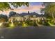 Exterior elevation with manicured landscaping and subtle lighting that enhances the property's charm at 10821 Club Point Dr, Fishers, IN 46037