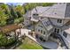 Stunning home showcasing beautiful stonework, manicured landscaping, and a charming pergola-covered patio at 10821 Club Point Dr, Fishers, IN 46037