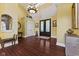 Grand foyer with dark wood floors, a decorative chandelier, and ornate details showcasing the home's luxury at 10821 Club Point Dr, Fishers, IN 46037