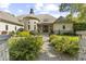 Imposing stone and stucco home with stone turret, beautiful walkway, and manicured shrubbery at 10821 Club Point Dr, Fishers, IN 46037