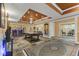 Basement game room with a pool table, bar area, and multiple seating options, and stone tile flooring at 10821 Club Point Dr, Fishers, IN 46037