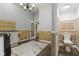 Hallway with travertine tile and a powder room at 10821 Club Point Dr, Fishers, IN 46037