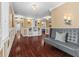 Spacious living room featuring hardwood floors, a gray leather couch, and built-in shelving at 10821 Club Point Dr, Fishers, IN 46037