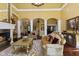 Spacious living room showcasing elegant decor, a cozy fireplace, and refined furnishings for luxurious comfort at 10821 Club Point Dr, Fishers, IN 46037