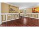 Elegant living room with hardwood floors, decorative trim, and bright, neutral walls at 10821 Club Point Dr, Fishers, IN 46037