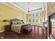 Inviting main bedroom with hardwood floors, large windows, and a decorative chandelier at 10821 Club Point Dr, Fishers, IN 46037