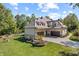 Aerial view of home, showcasing expansive backyard, three-car garage, and lush surroundings at 10821 Club Point Dr, Fishers, IN 46037