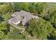 Aerial view showcasing property's detailed landscaping, multiple outdoor living areas, and surrounding greenery at 10821 Club Point Dr, Fishers, IN 46037