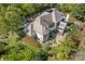 Aerial view showing back of house, patio, luxurious landscaping, and neighborhood at 10821 Club Point Dr, Fishers, IN 46037