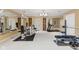 A large workout room featuring various exercise machines, mirrored walls, and carpet flooring at 10821 Club Point Dr, Fishers, IN 46037